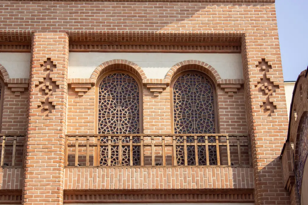 Islamic architecture with arched windows and brickwork.