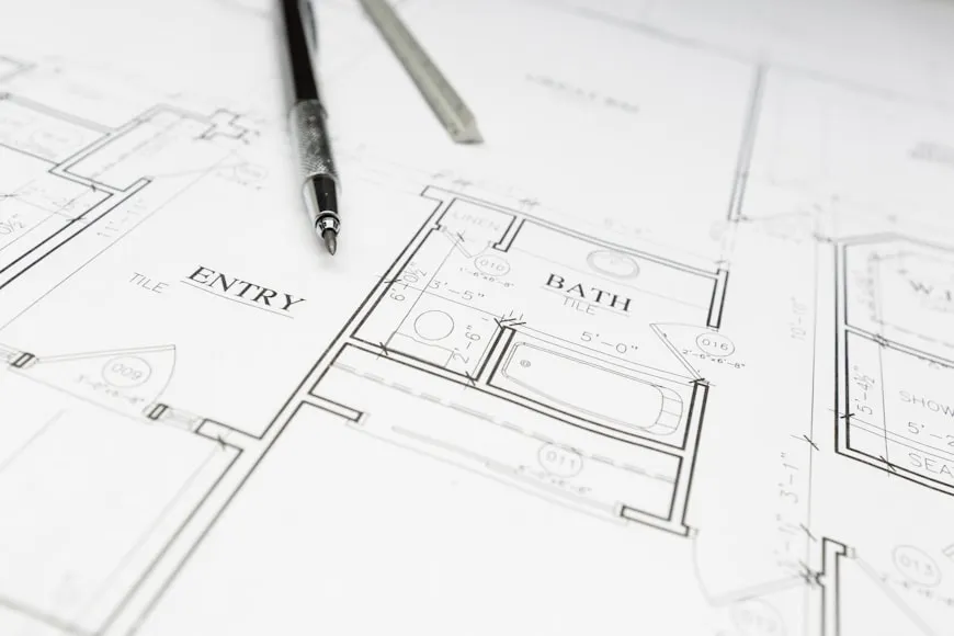 Engineer Pencil and Ruler Resting on Custom House Plans.